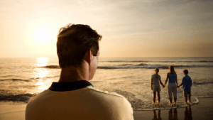 man watching family sunset